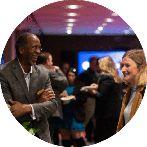 A man and a woman looking at each other, smiling and laughing